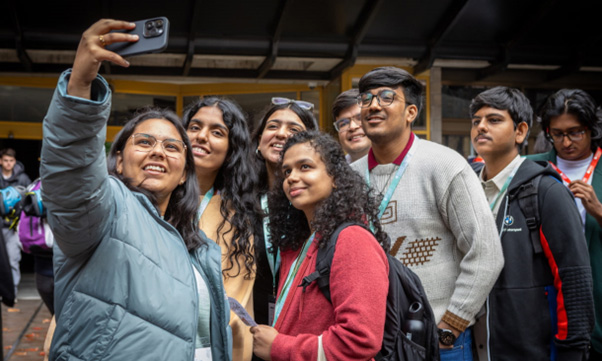 Educator and students taking selfie photo.