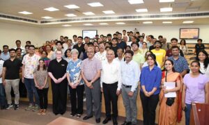 A large group of BITS Pilani staff smiling and posing together.